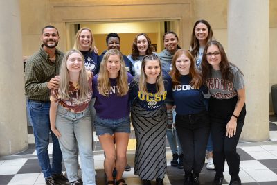 Eleven members of the Higher Education master's program's Class of 2023 pose for a photo in the Gentry Building.