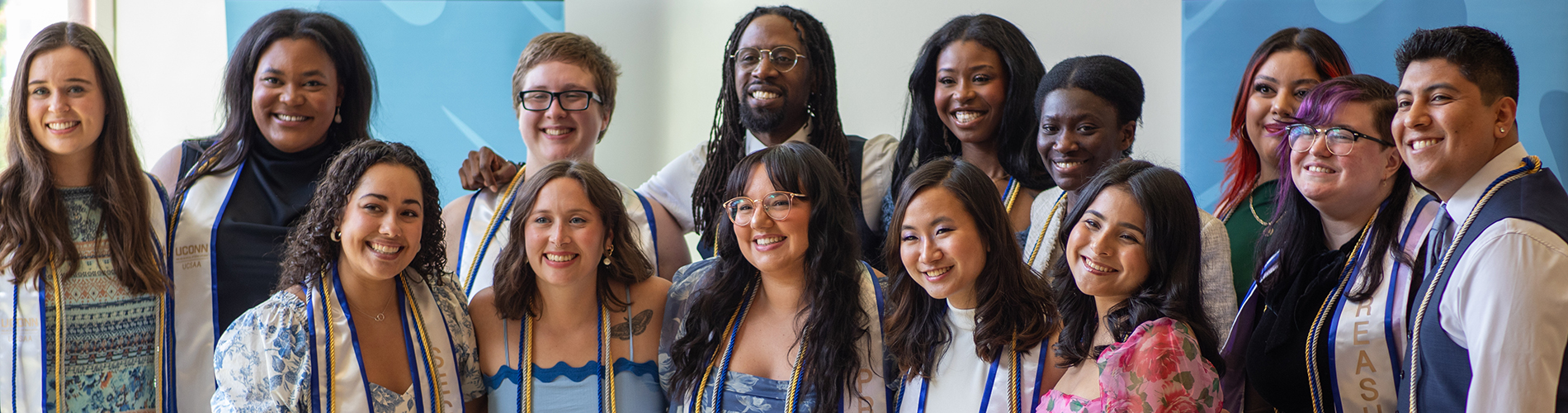 UConn's Class of 2024 higher education master's program graduates pose together as a group.